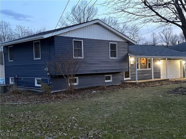 view of home's exterior with a lawn and a garage