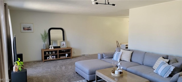 living area featuring visible vents, baseboards, and carpet