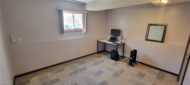 interior space featuring light colored carpet and baseboards