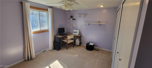 office with visible vents, light carpet, baseboards, and ceiling fan