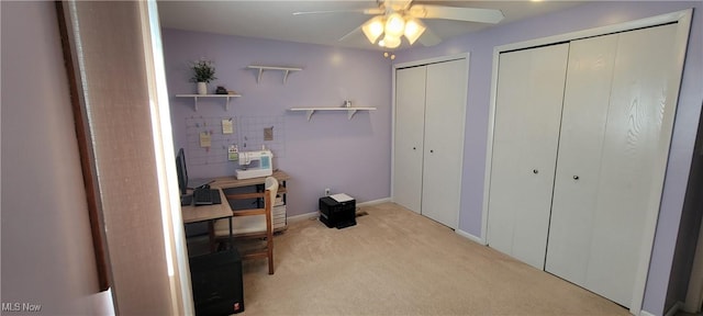 bedroom with baseboards, multiple closets, carpet, and a ceiling fan