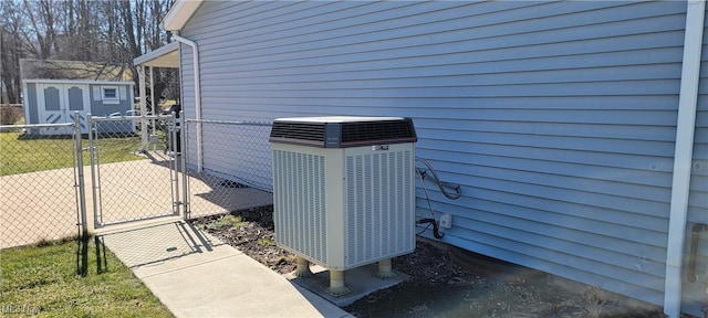 details with a gate, cooling unit, and fence