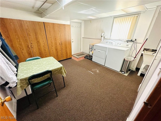 washroom featuring dark colored carpet, washing machine and dryer, and laundry area