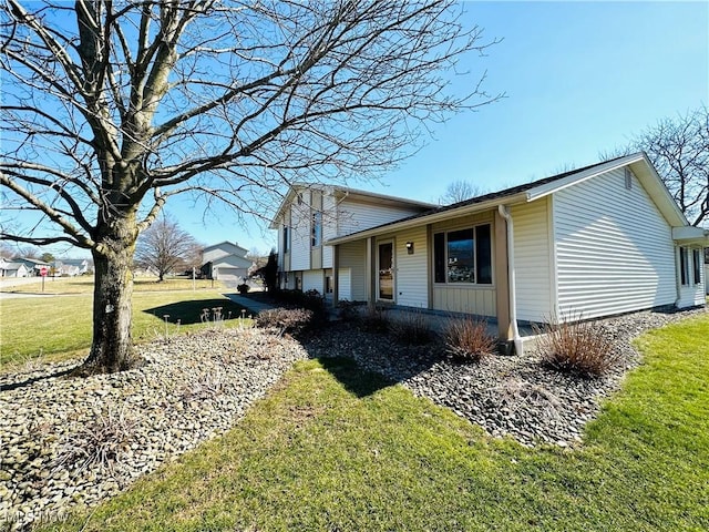 view of property exterior with a lawn