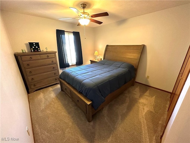 carpeted bedroom featuring baseboards and ceiling fan