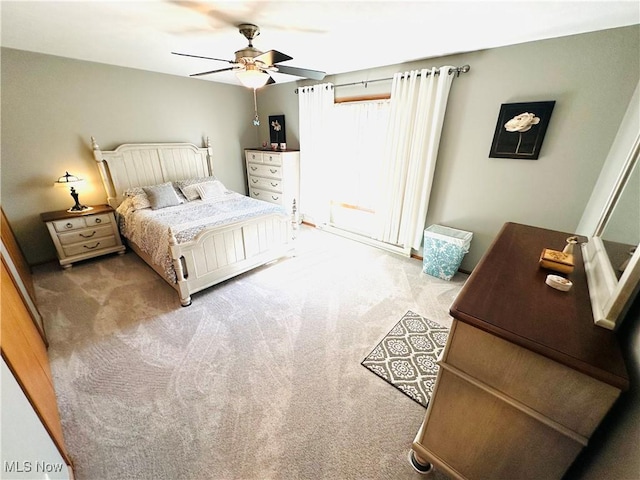 bedroom with a ceiling fan and carpet