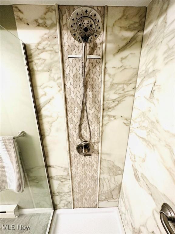 full bathroom with a marble finish shower