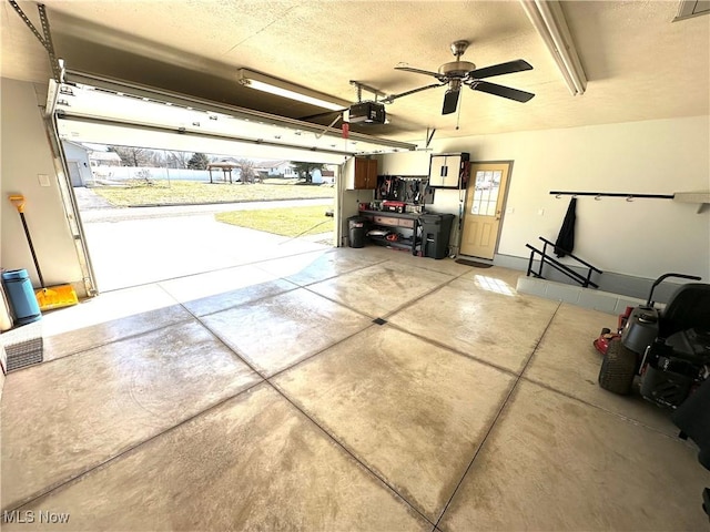 garage with visible vents, a garage door opener, and a ceiling fan