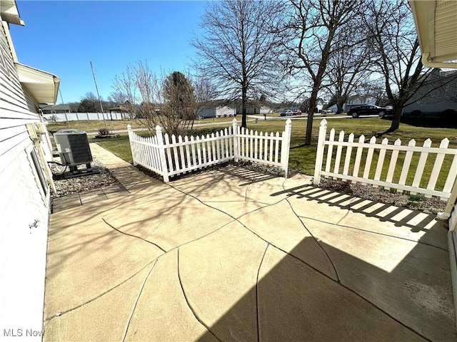 view of patio / terrace featuring central AC unit and fence