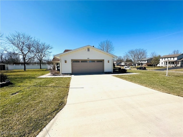 view of side of property featuring a yard, an attached garage, driveway, and fence