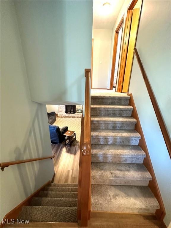 staircase with wood finished floors