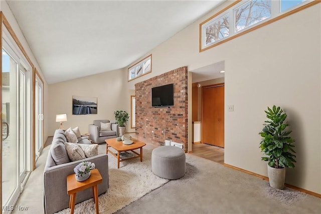 living room with baseboards and high vaulted ceiling