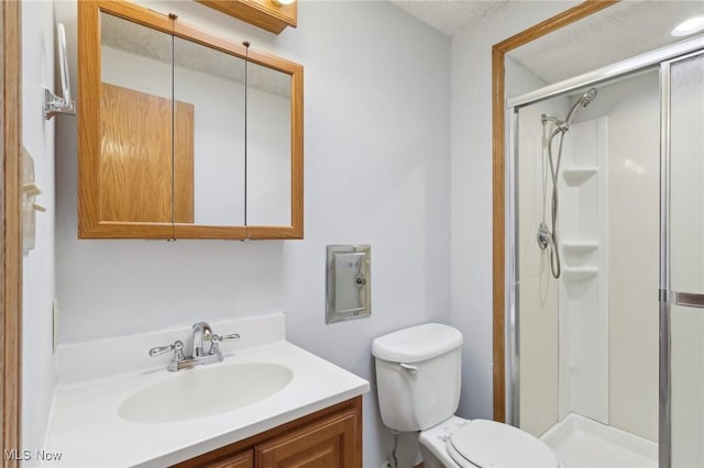 full bath featuring vanity, a shower stall, and toilet