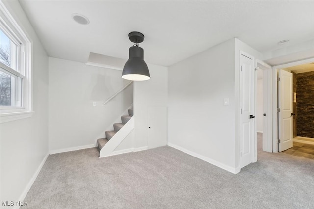 interior space featuring baseboards, carpet, and stairs