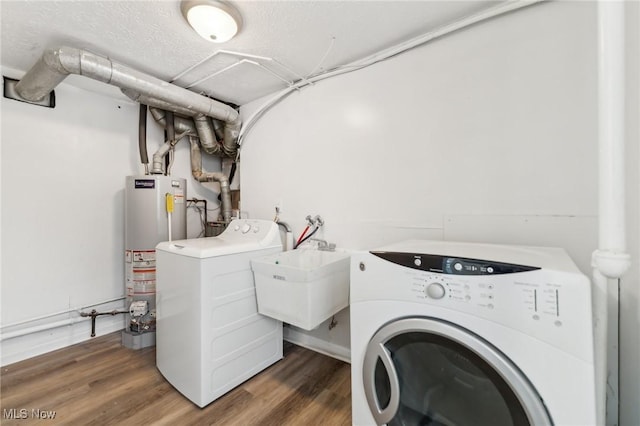 laundry area featuring gas water heater, wood finished floors, separate washer and dryer, and a sink