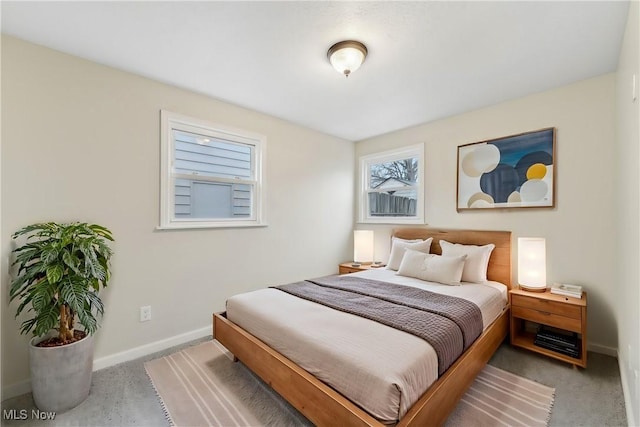 carpeted bedroom featuring baseboards