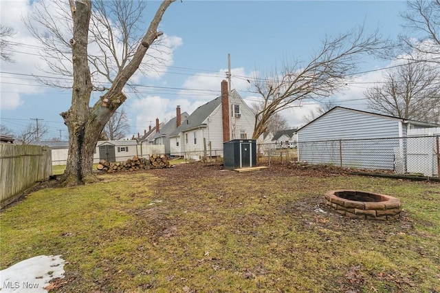 view of yard featuring an outdoor fire pit and a fenced backyard