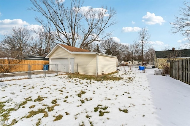 exterior space with an outbuilding, a garage, and fence