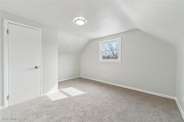 additional living space featuring lofted ceiling, carpet, and baseboards