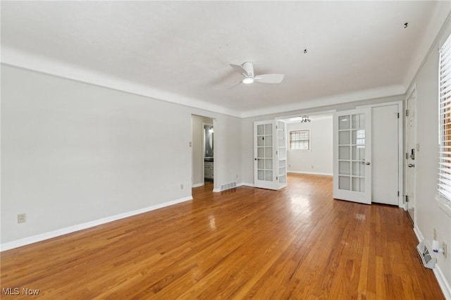 spare room featuring a ceiling fan, visible vents, baseboards, french doors, and light wood-style floors