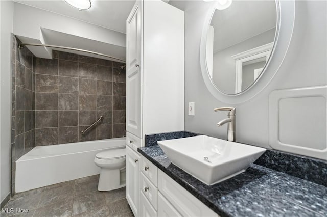 full bathroom featuring vanity, bathing tub / shower combination, and toilet