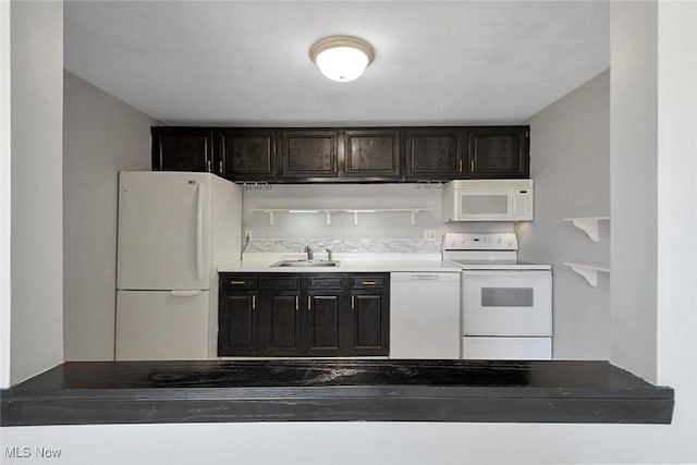 kitchen featuring white appliances and a sink