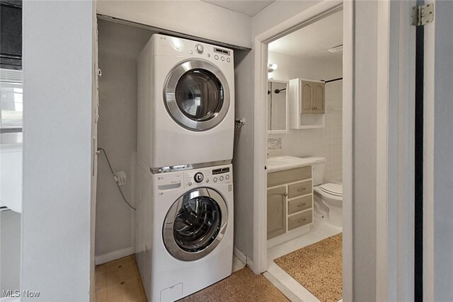 laundry area with stacked washer and clothes dryer and laundry area