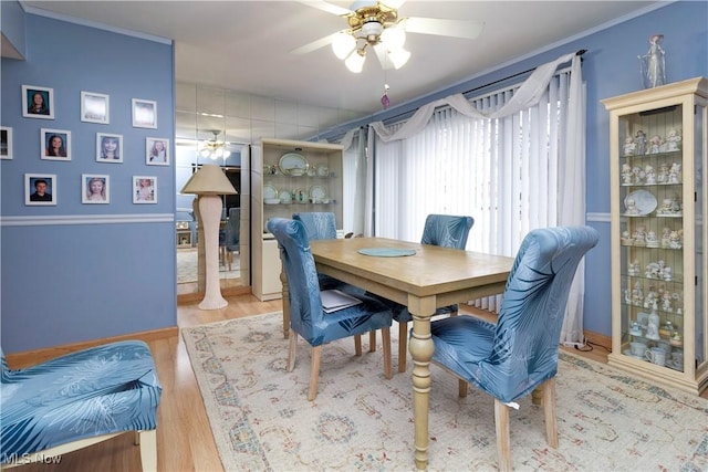 dining space featuring ornamental molding, ceiling fan, and wood finished floors