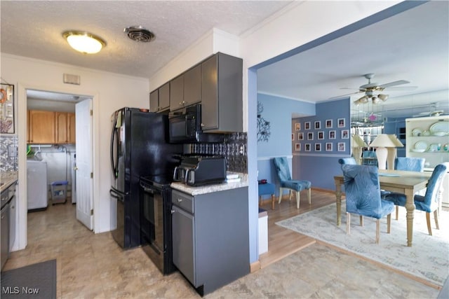 kitchen featuring decorative backsplash, black appliances, visible vents, and ornamental molding