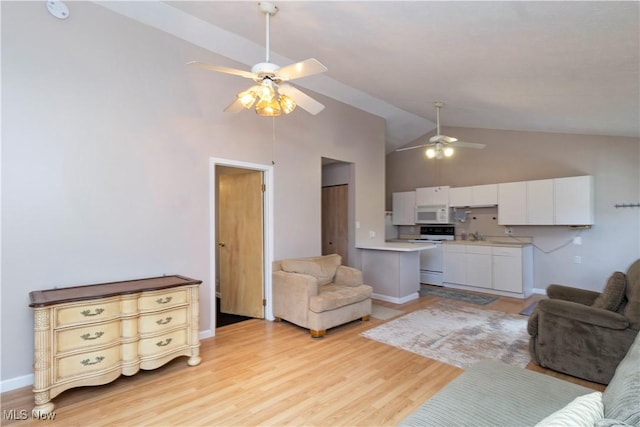 living area featuring baseboards, high vaulted ceiling, light wood-style flooring, and a ceiling fan