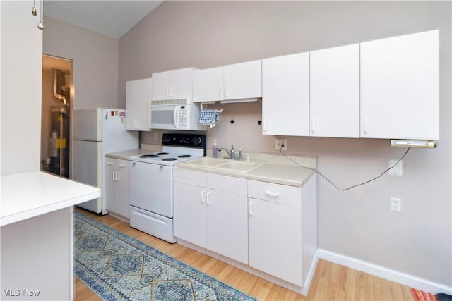 kitchen featuring white appliances, a sink, light countertops, white cabinetry, and gas water heater