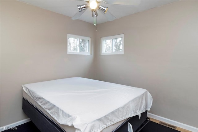 bedroom featuring visible vents, baseboards, and ceiling fan