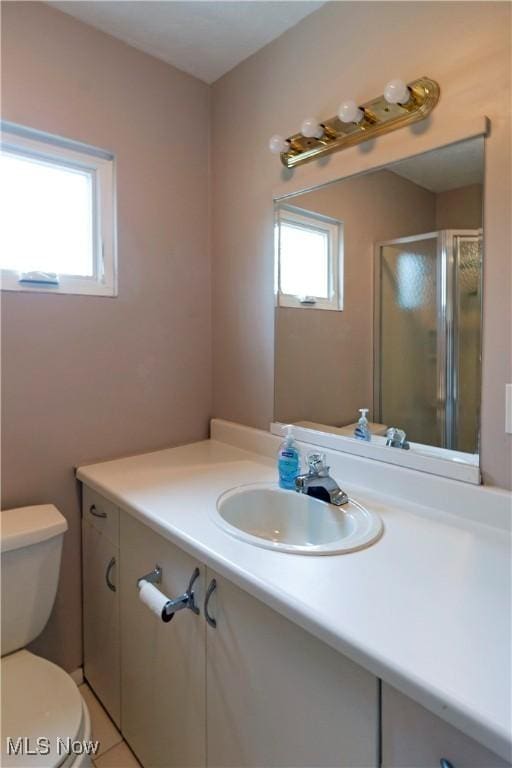 full bathroom with vanity, toilet, and a stall shower