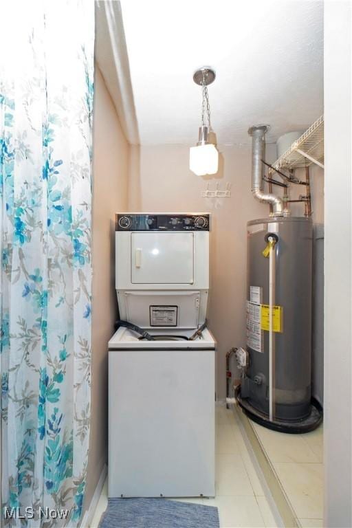 utility room featuring gas water heater and stacked washer and dryer