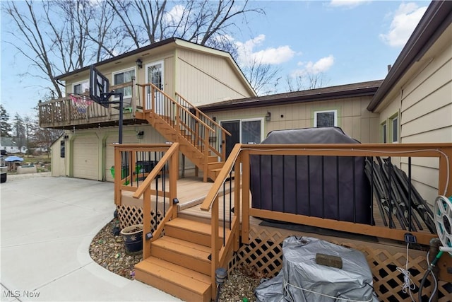 wooden terrace with stairway, concrete driveway, and an attached garage