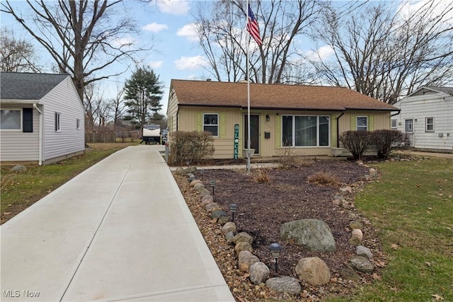 single story home with board and batten siding and driveway