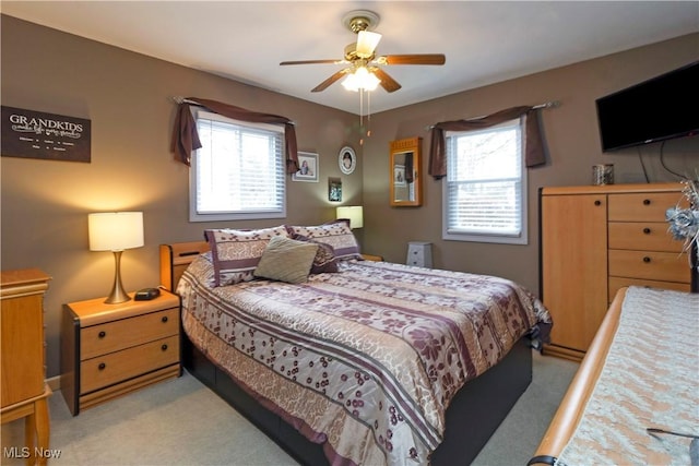 bedroom with light colored carpet and ceiling fan