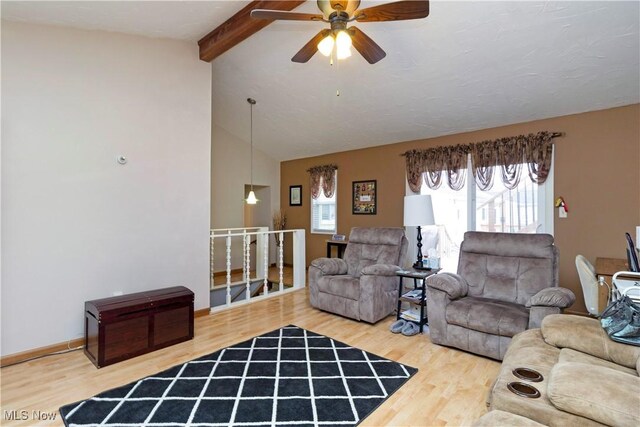 living room with vaulted ceiling with beams, a ceiling fan, baseboards, and wood finished floors