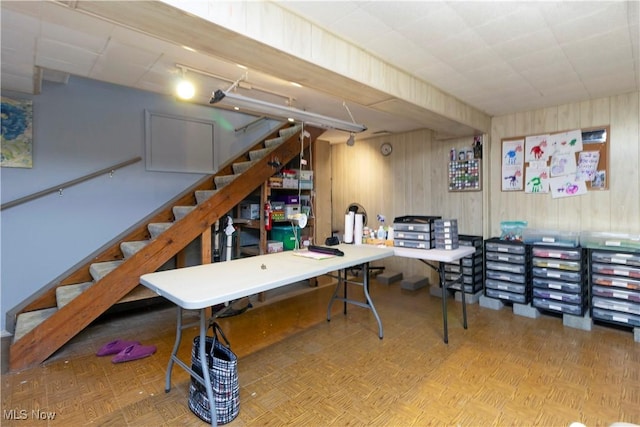 interior space featuring stairway and wood walls