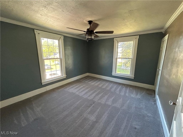 carpeted empty room featuring baseboards, plenty of natural light, a textured ceiling, and ornamental molding