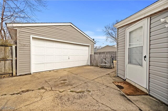 detached garage featuring fence