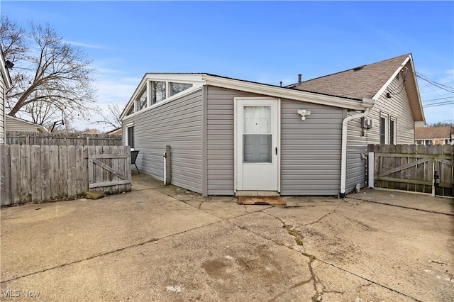 back of property with a gate, a patio, and fence