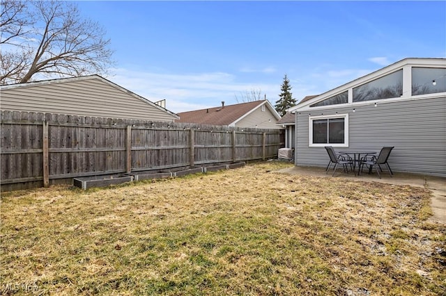 view of yard with a fenced backyard and a patio area