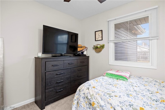 bedroom with ceiling fan, baseboards, and light carpet