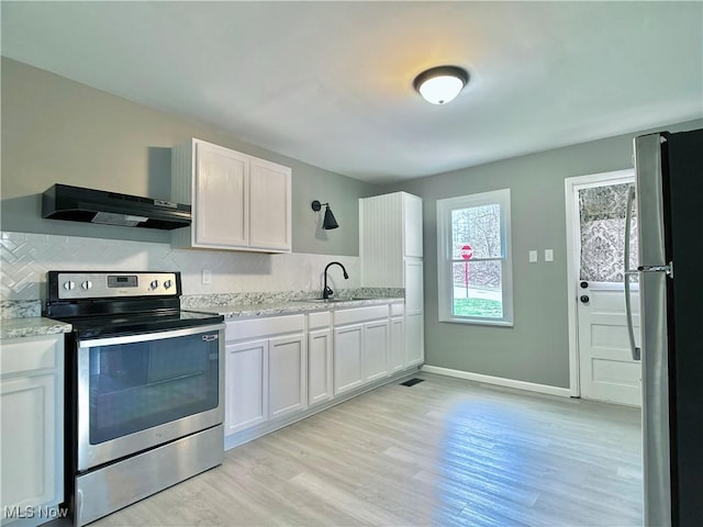 1341 Sharon Ave, Zanesville, OH 43701 - kitchen featuring a sink, white cabinetry, under cabinet range hood, stainless steel appliances, and light wood-style floors