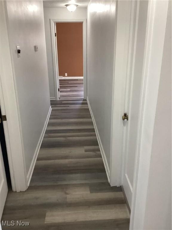 hall with wood finished floors and baseboards