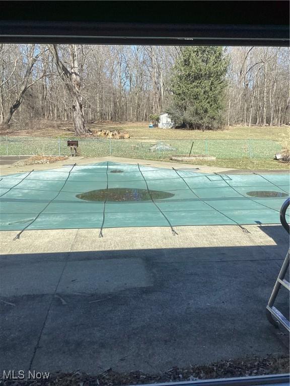 view of swimming pool with a covered pool