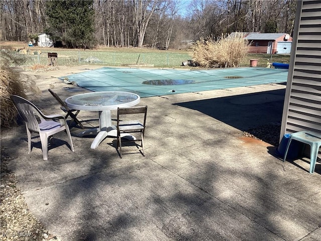 view of swimming pool featuring a covered pool and a patio