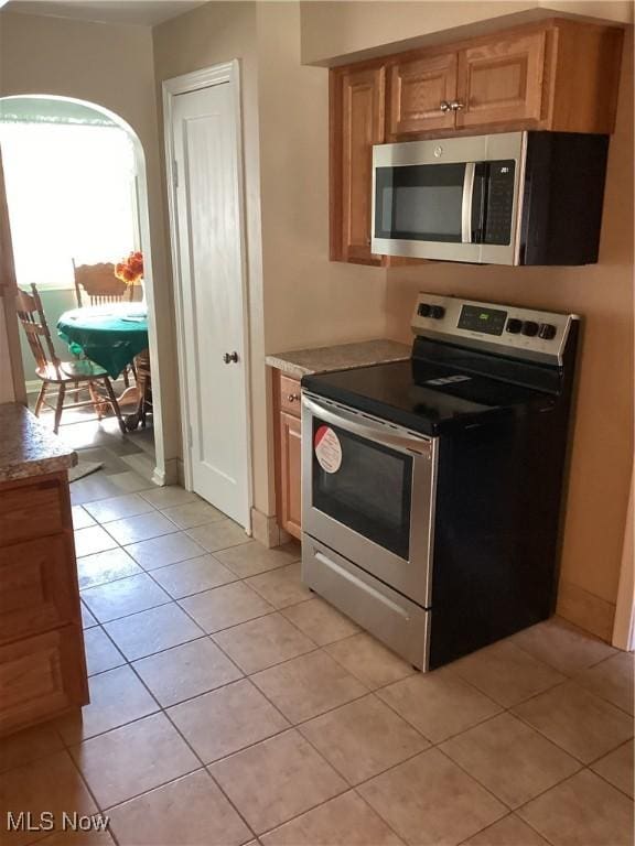 kitchen featuring light tile patterned floors and appliances with stainless steel finishes