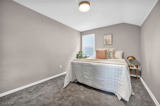 bedroom with vaulted ceiling, carpet flooring, and baseboards